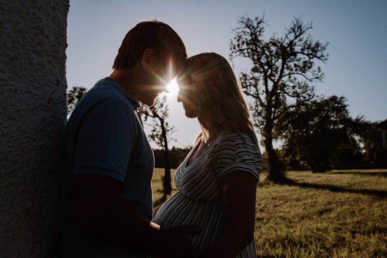 Goldene Stunde - Babybauch Fotos in der Natur mit Bäumen im Hintergrund